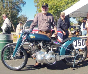 The “Voice of Hansen Dam” for decades has been SoCal Norton Club honcho Bill “Bib” Bibbiani, a bull-horn always close at hand. The bike is Marty Dickerson’s famous record-breaking Vincent racer.