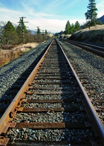 The railroad tracks adjacent to I-84 run to the horizon.