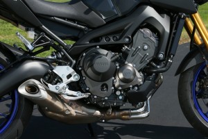 Exposed in-line triple with low-slung exhaust gives the FZ-09 a raw, mechanical look.