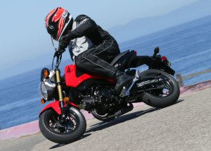 A wide handlebar, small tires and short wheelbase help the 2014 Honda Grom 125 carve corners quickly.