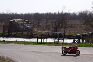 When storm surges topped the levees, the low-lying areas behind the levee filled with water. Boats that rode atop the storm surge ended up on the wrong side of the levee when the water receded.