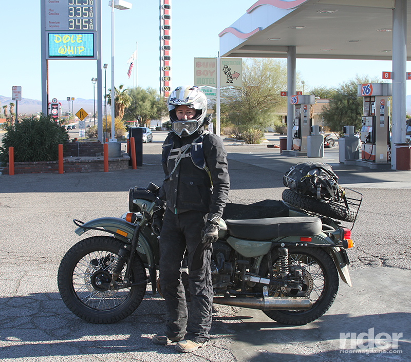The Ural & I: The author poses with her 2016 Ural Gear-Up in Baker, California, where the World's Tallest Thermometer (seen in the background) indicated 50 degrees. (Photos by Kurt Yaeger)