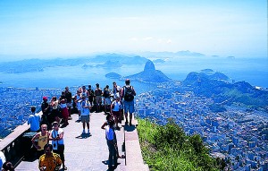 I’m standing on the 2,000-foot hill called Corcovado near Rio’s center, looking out over the Bay of Guanabara.