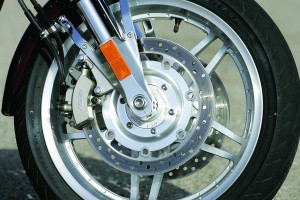 When the rear brake is applied, its linkage also activates a piston on each front disc.