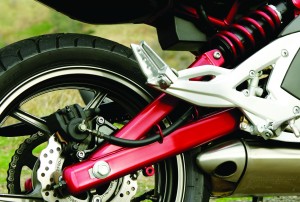 Tubular-steel swingarm connects to a single right-side shock.
