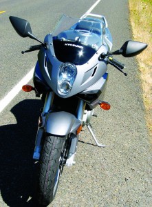 Half-fairing and V-twin engine show a narrow profile to the wind.