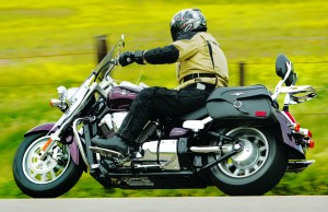 The Suzuki rider is spread out and finds that turning the bike requires a lot of effort.