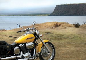 Motorcycle with a sea cliff at South Point in Hawaii