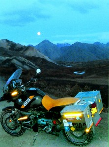 A full moon casts a cool light over the landscape.
