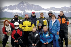 Women riders in front of the Alaska Range