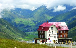 ustic hotel on the way down the Furkapass toward Andermatt, Switzerland, with the glorious Oberalpass in the background.
