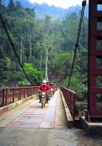 Crossing a bridge leading out of Ba Be National Park.