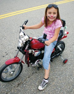 Little girl on a little bike.