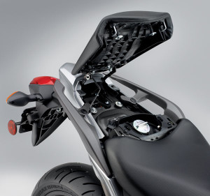 2012 Honda NC700X: Access to the 3.7-gallon fuel tank is under the passenger seat.