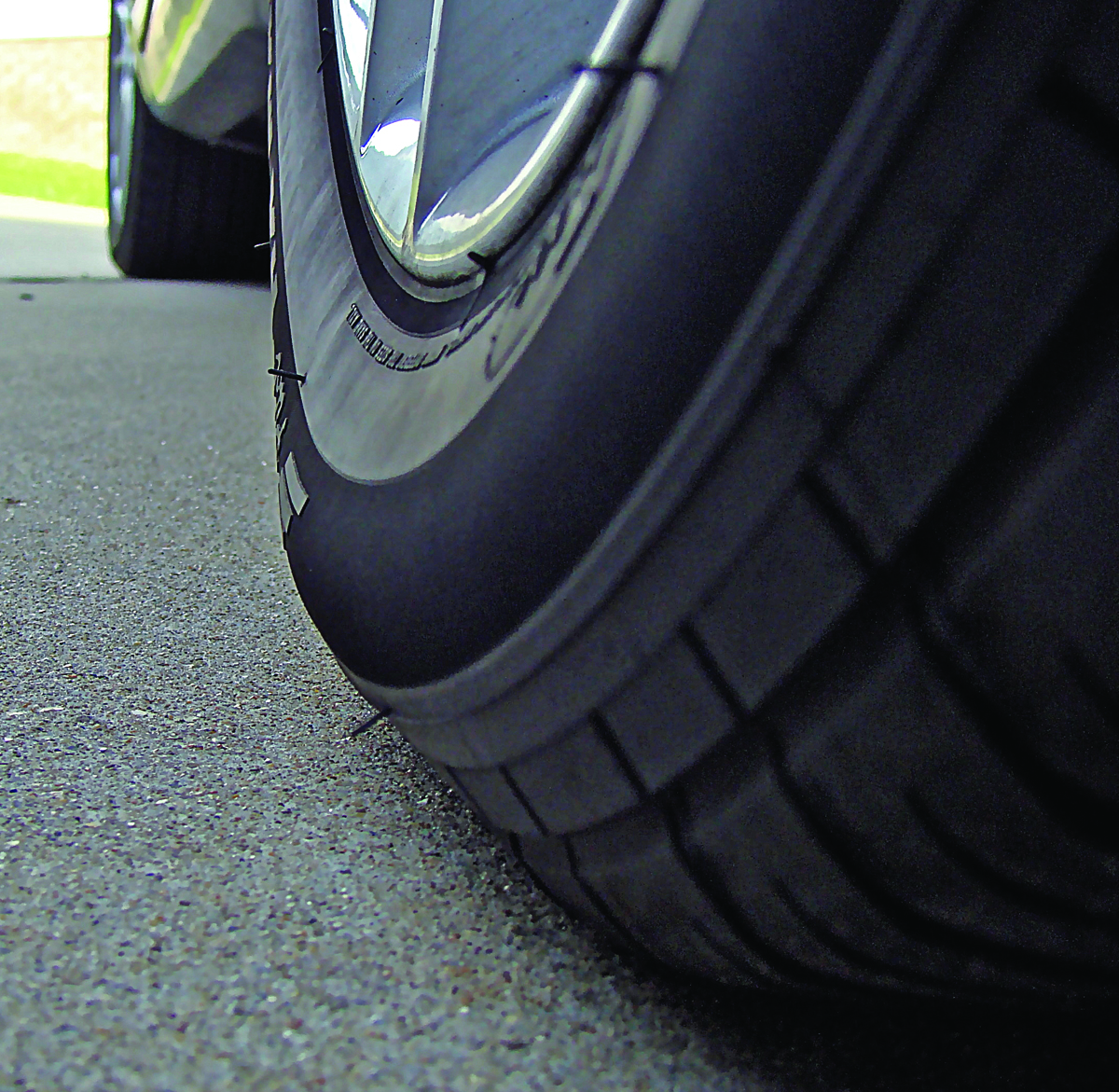 This low-profile car tire begins to bulge when tire pressure drops below 25 psi.