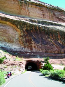 Tunnel carved out of red sandstone on the road in Colorado National Monument.