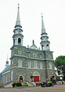The twin spires of Église Notre-Dame-de-Bonsecours (c. 1768) rise above the southern bank of the St. Lawrence River at L’Islet-Sur-Mer.