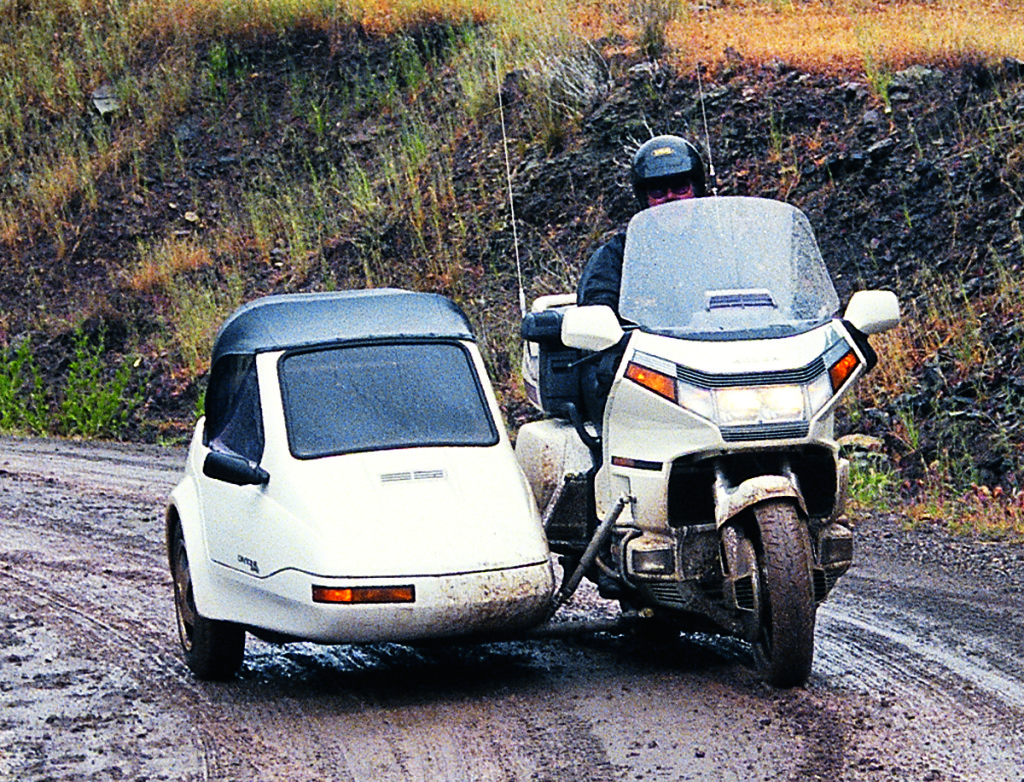 A third wheel can be very useful on a wet dirt road; this car is a Champion Daytona 2+2.
