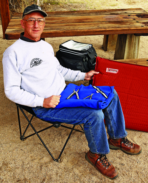 A simple old folding camp chair, Roadgear fleece blanket, Therm-a-Rest air mattress and his favorite tankbag keep Bill happy.