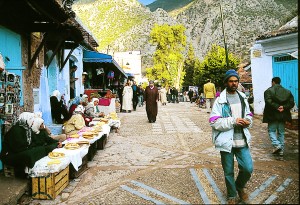 Woman making and selling flatbreads in the open marketplace in Chefchaouen.