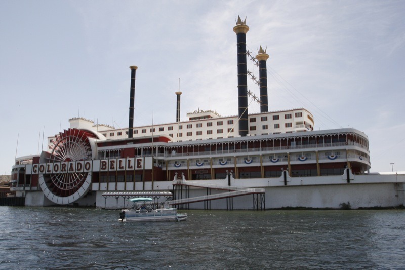 Private boats and water taxis on the Colorado River are dwarfed by the landmark Colorado Belle Hotel and Casino.