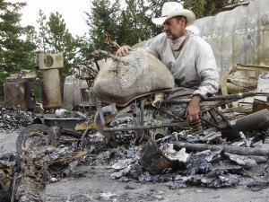 Jim Key looks over the remains of one of his motorcycles during the difficult days after the fire.