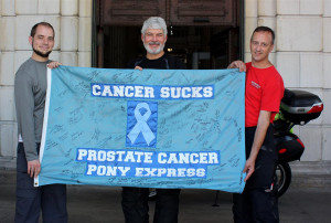 Left to right: Mike Breton, Bob Fortuna and your humble scribe with the “Cancer Sucks” banner at the Statehouse in Providence, Rhode Island. (Photo by Scott A. Williams)