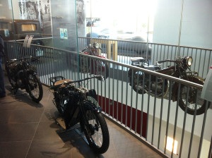 Motorcycles are mixed in among the historic automobiles.