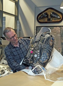 Which came first? The jacket or the bike? Curator James Fricke prepares a leather jacket for a special exhibit “Worn To Be Wild.”