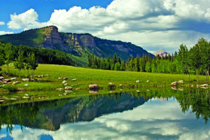 The Million Dollar Highway winds along towering cliffs and serene mountain lakes.