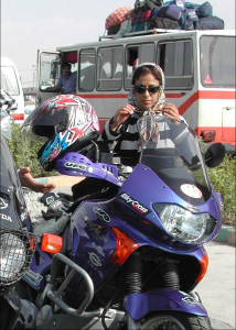 The author donning a scarf after removing her helmet in Teheran.