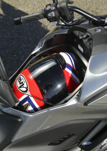 Integrated storage compartment holds 21 liters of stuff or a full-face helmet.