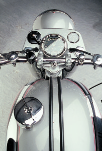 The Smith’s chronometer is new. The large filler cap and big tank were intended for distance racing. British motorcycle manufacturers were always partial to levers—the left lever is the manual advance, the black item next to it is the light switch, the button is a kill switch and the choke is mounted on the right.
