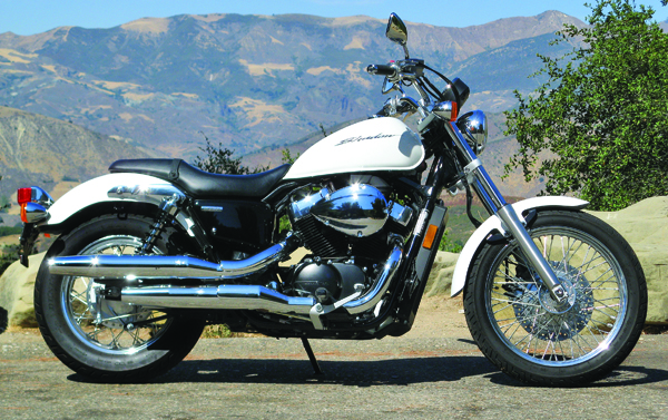 Long and low, the Honda Shadow RS takes styling cues from Harley Sportsters past, while integrating liquid cooling and an overhead cam engine. The RS’s upright seating position is downright comfortable, thanks to slightly forward pegs and mildly swept bars that fall naturally to hands and feet.