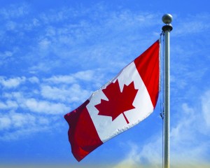 The Canadian flag flies high overhead.