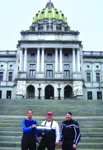 Harrisburg, Pennsylvania: “As the skies parted and gave a brief moment of sunlight,” recalls Randy Bridgewater (right), “we moved quickly to the Capitol steps.” Also pictured are Michael Boucher (left) and Tom Melnik (center). (PHOTO BY TOM MELNIK)