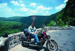 THE AUTHOR AT HAWKS NEST SCENIC OVERLOOK, WHERE THE ROAD IS CUT INTO THE MOUNTAINSIDE.