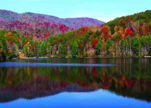 A lake refl ects the fall colors of the surrounding mountains on State Route 60.