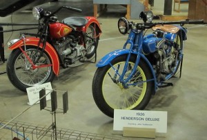 Two immaculately restored vintage bikes are displayed amidst the aircraft at the New England Air Museum.