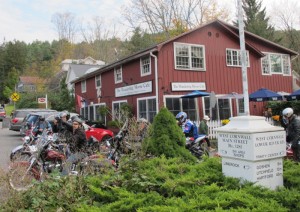 Bikers congregate at a popular way stop in the village of West Cornwall adjacent to its iconic covered bridge.