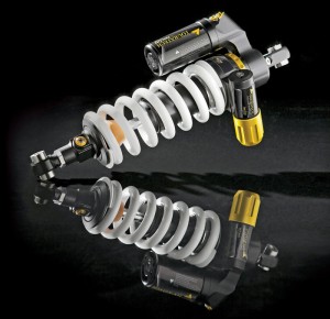 Rear shocks are equipped with either a piggyback or remote reservoir depending on the bike model. Note the rebound damping and length adjusters on the bottom of this Extreme shock.