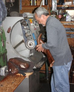 Behind the counter, Ace Shoe Repair looks a lot like a machine shop. Here, Ace uses a grinder to prepare a boot heel for a new sole.