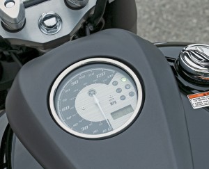 Flat-black tanktop console includes a speedometer and an LCD clock/odometer/tripmeter. Buttons on the right switchpod select and reset functions.