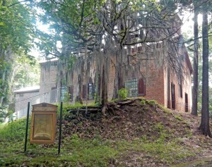 Gray beards of Spanish moss wave gently in the breeze beside this Methodist Church, the only remaining building in Rocky Springs, Mississippi.