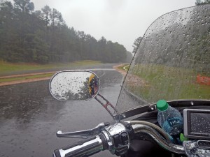 Waiting out the downpour. Note the treacherous, muddy shoulders bracketing the roadway.