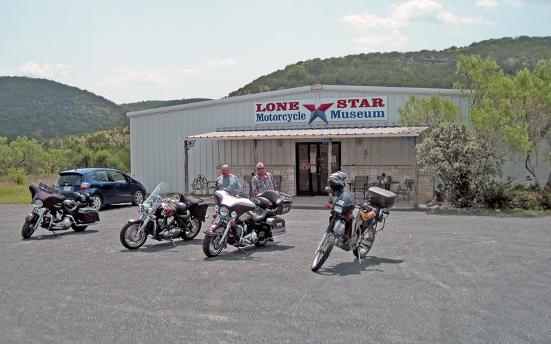 Two Harleys, two Hondas (the blue one with four wheels is a Honda too) and a Kawasaki at the Lone Star Motorcycle Museum in Vanderpoole. The Kawasaki KLR is mine! It was a slow day as temps were in the triple digits. 