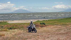 Our Estonian companion is riding along the shore of Lake Nicaragua, with volcanic islands in the background.