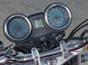 Round gauges flank an LCD display with fuel gauge, tripmeters and clock.