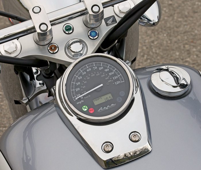Chrome tanktop console includes a speedometer and an LCD clock/odometer/dual tripmeter. Indicator lights on the triple clamp make them easier to see.