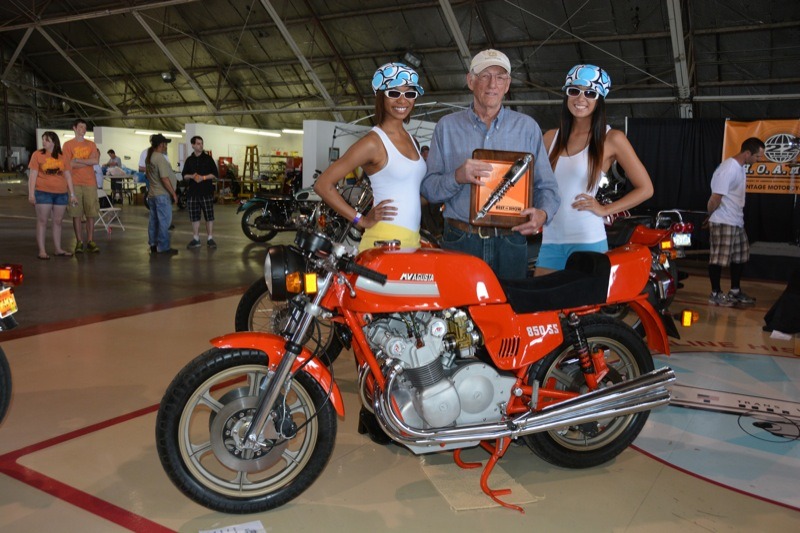 Dale Keesecker won Best in Show with his immaculate 1977 MV Agusta 850 SS. Umbrella Girls Leah Ricketts and Stephanie Hille presented the award to him